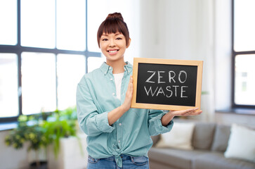 eco living, environment and sustainability concept - portrait of happy smiling young asian woman in...
