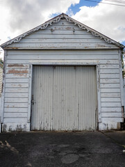 Old white garage with pitched roof