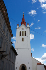 Facade of the old church of St. John against the blue sky in Cesis, Latvia
