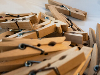 Mound of wooden clothespins on white background