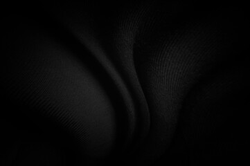 Black fabric sheets background or texture, abstract with waves, Soft focus cloth silk black