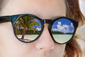 Beach reflections in a girl sunglasses, travel and summer concept