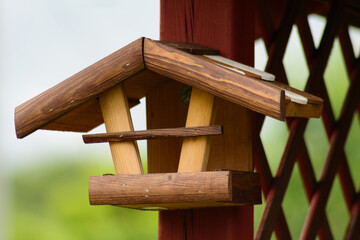 the bird feeder was hung on the garden gazebo