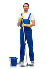 profession, service and people concept - happy smiling male worker or cleaner in overall and gloves cleaning floor with mop and bucket over white background