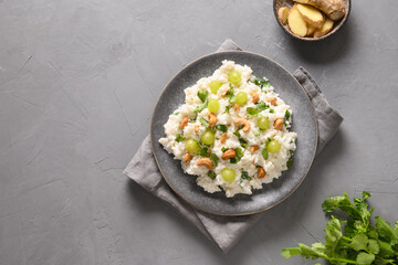 Curd Rice with cashews, grapes, cilantro on a grey background. View from above. Copy space. Indian South cuisine
