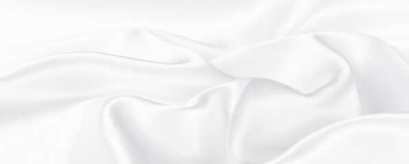 Fototapeta premium Abstract white silk fabric texture background. Cloth soft wave. Creases of satin