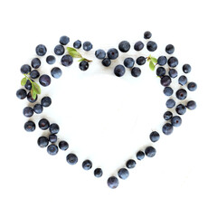 blueberries in the shape of a heart on a white table top view. favorite sweet summer
