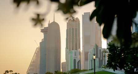 Colorful Skyline of Qatar City during sunset. with leaves in the frame.