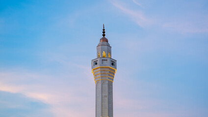 Muslim mosque minaret with dark cloud during the rainy day in Qatar