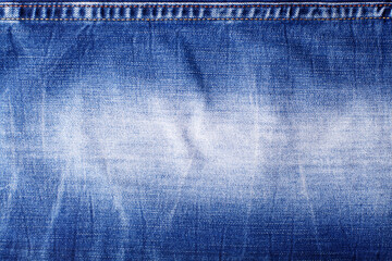 Blue jeans texture with seam close up, thread stitch on jean textile background, blue denim...