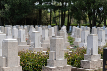 Fototapeta na wymiar Many tombs in rows, graves on military cemetery