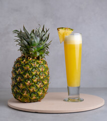 Refreshing freshly made fruit juice on a glass , fresh pineapple juice.