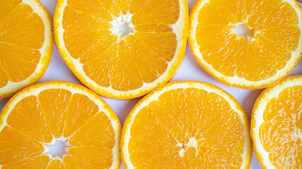 Large orange slices close up. Orange circles on a white background. Perfectly constructed fiber. Healthy life