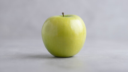 Fresh single Green Apple Isolated on Gray Background.