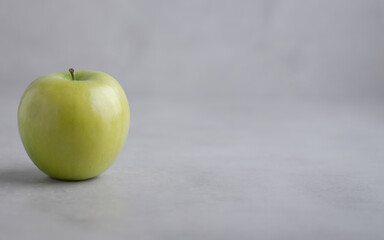 Fresh single Green Apple Isolated on Gray Background.