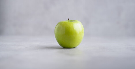 Fresh single Green Apple Isolated on Gray Background.