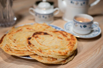 home made paratha desi Pakistan and Indian food with chai tea on table