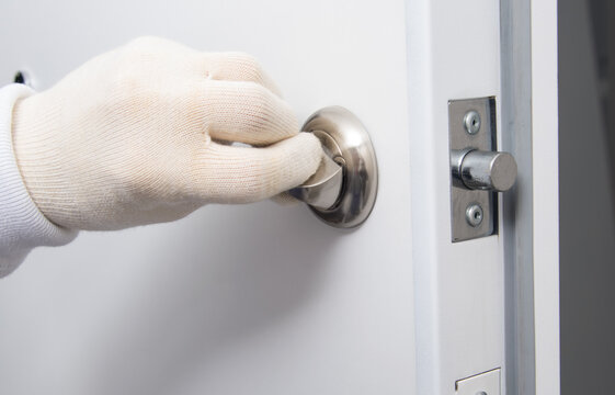 Close-up, A Gloved Hand Checks The Correct Operation Of The Front Door Latch, Closing And Opening From Inside The Apartment