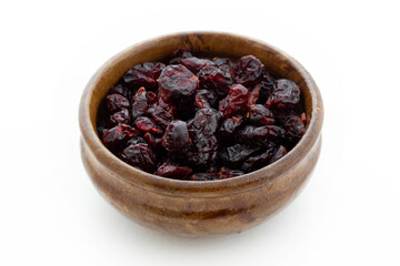 Dried blueberries in wooden bowl. Dry fruits.