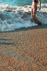 woman in swimsuit in sea waves, copy space