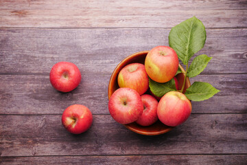 Close up of fresh apple in a bowl on wooden table 