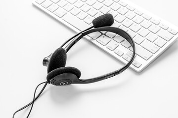 Voip headset on computer laptop. Hotline or call center support