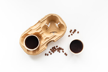 Flat lay of black coffee in paper cups with beans