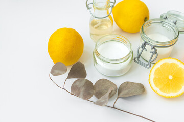 Set of eco cleaning products. Eco sponges, lemons, apple vinegar, citric acid and soda on white background.