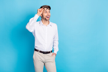 Photo of amazed shocked young happy man look empty space news sale isolated on blue color background