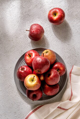 Ripe red apples on grey plate. Top view with space for your text.