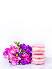 Macaroon cakes and a bouquet of flowers. Romantic gift. Macaroon copy space