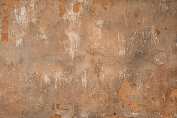 Shabby old wall with peeling paint concrete textured backdrop background brown gray