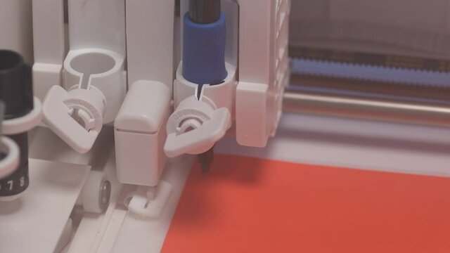 Digital cutting and creasing plotter draws letters