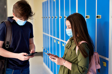 School children using smartphone during a pandemic