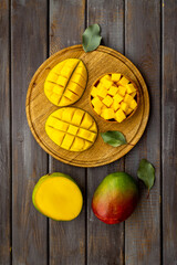 Mango fruit and mango cubes in bowl. Fruits background