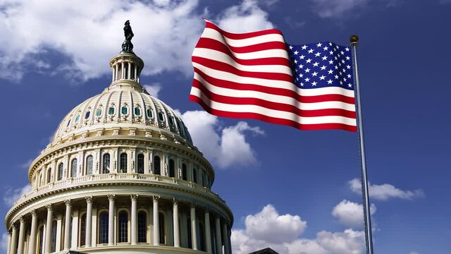 Capitol dome and American flag against the background of moving clouds on the 
Independence Day of the United States of America. 

 