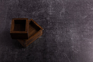 Two wooden food boxes on a dark background