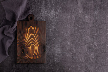 Old dark cutting board on dark background
