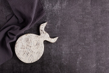 An empty vintage cutting board in the shape of a bull. White color