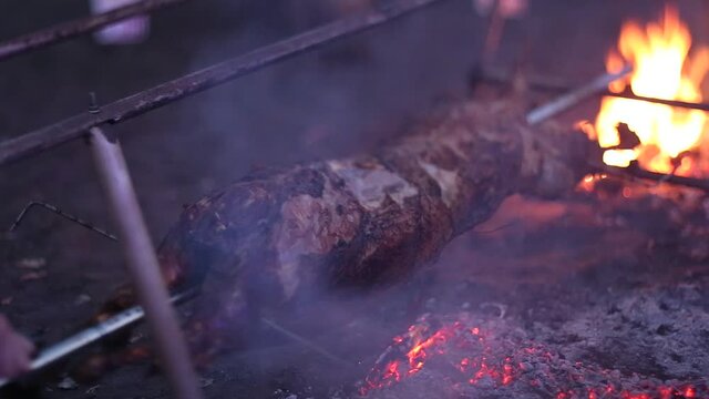 Patagonian roast lamb, tipical dish of Chile and Argentina, cooked very slowly over the embers of hot burning hard wood