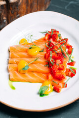 salmon fish slices decorated with strawberry slices.