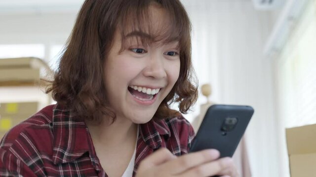 Young attractive beautiful female entrepreneur fund borrower crazy joyful ecstatic face gesture hand yes feeling amazed in peer to peer P2P lending finance or crowdfunding network microfinance approve