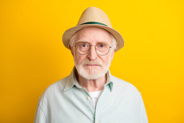 Photo of serious confident age gentleman wear green shirt headwear spectacles isolated yellow color background