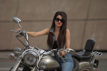 Portrait of young woman on a motorcycle