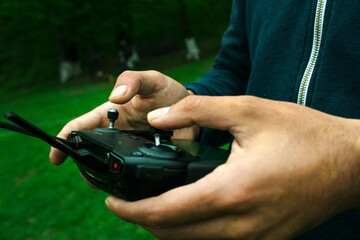 a man controls the drone's remote control