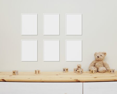 6 blank vertical frames mockup on wall for nursery wall art display, baby room six white frames mock up, wooden shelf, soft toys and wooden toys on shelf.