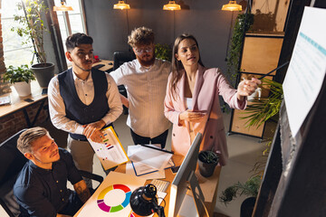Colleagues working together in modern office using devices and gadgets during creative meeting