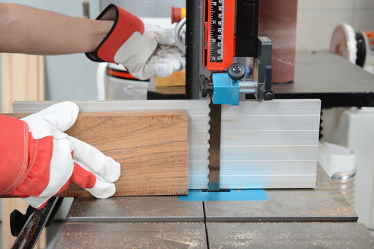 Cutting of ovangkol wooden plate on band saw. Guitar making