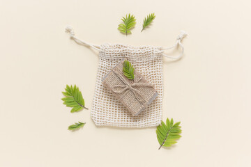 Eco friendly natural solid soap in natural packaging on a beige background. Zero waste concept....