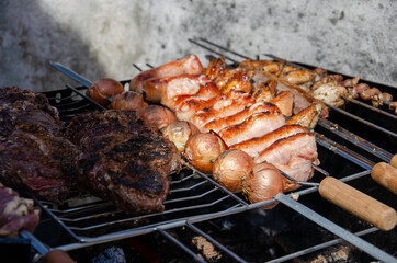 close up on a barbecue grill full of meat and onions, brazilian style